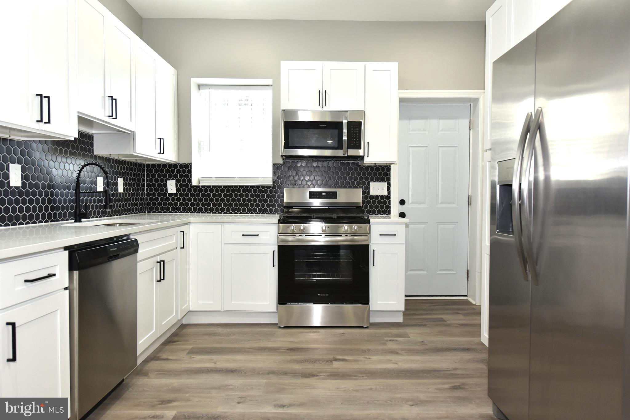 2225 West Baltimore Street Baltimore, MD 21223 - Photo 7 of 46 a kitchen with stainless steel appliances granite countertop a stove and a refrigerator