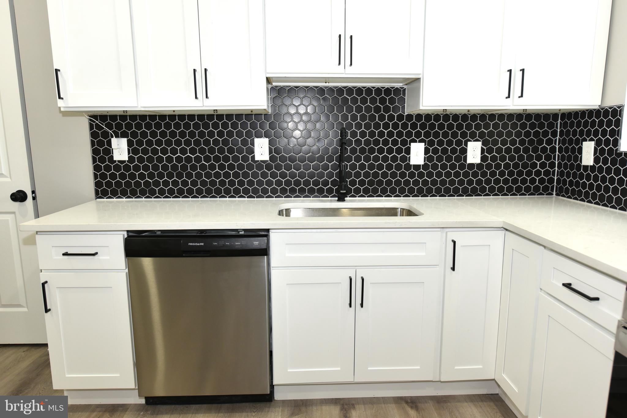 2225 West Baltimore Street Baltimore, MD 21223 - Photo 8 of 46 a kitchen with white cabinets and sink
