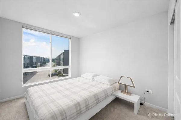 a large bed sitting in a bedroom next to a window