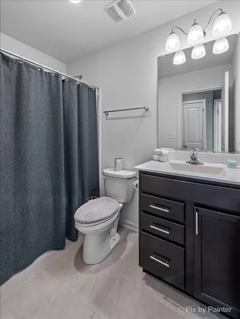 a bathroom with a sink vanity mirror and toilet