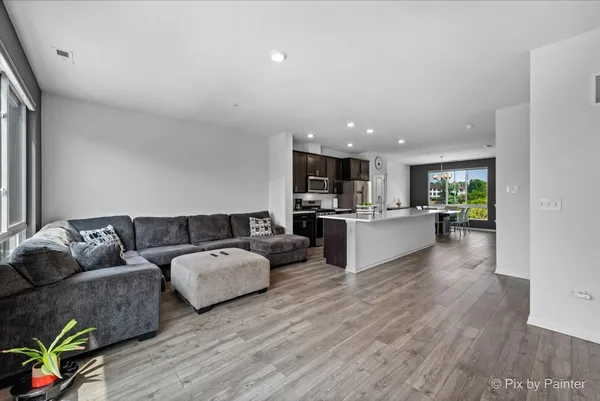 a living room with furniture and a wooden floor