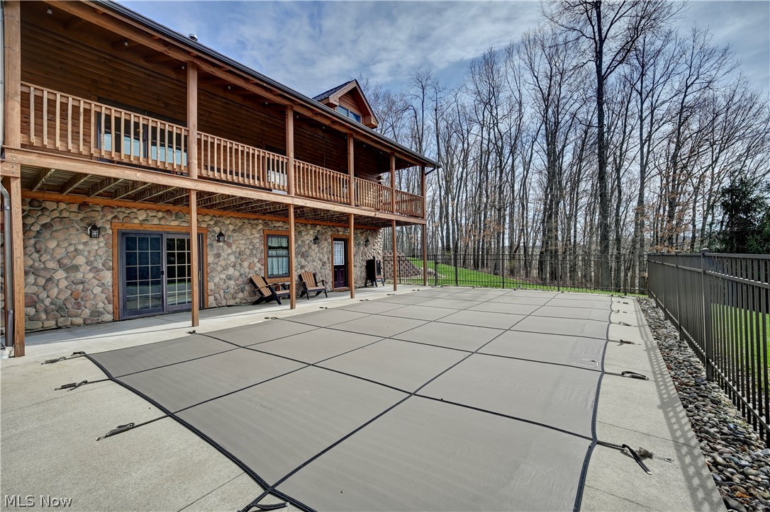 8045 McFadden Road Shreve, OH 44676 - Photo 18 of 45 Back of house featuring a patio, stone siding, and a fenced backyard