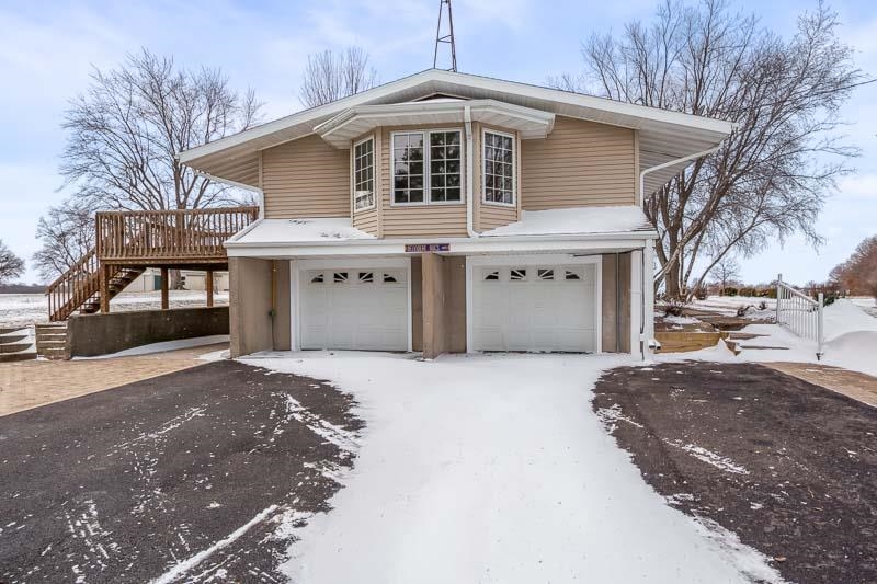 8611 Huber Road Belvidere, IL 61008 - Photo 18 of 79 a front view of a house with a yard and garage