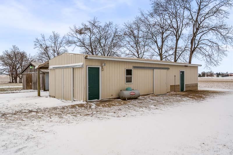 8611 Huber Road Belvidere, IL 61008 - Photo 23 of 79 a front view of a house with a yard and garage