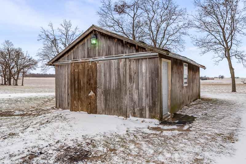 8611 Huber Road Belvidere, IL 61008 - Photo 24 of 79 a front view of a house with a yard covered in snow