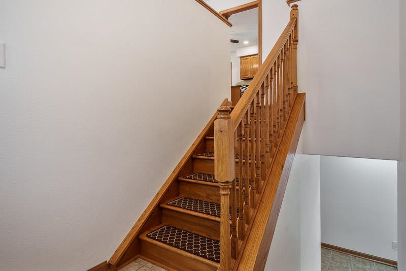 8611 Huber Road Belvidere, IL 61008 - Photo 26 of 79 a view of staircase with wooden floor and white walls