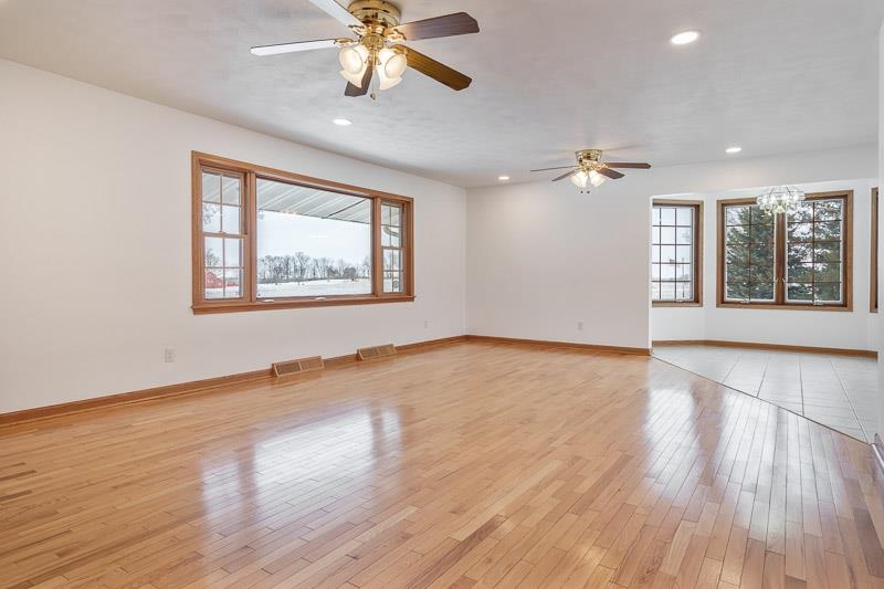 8611 Huber Road Belvidere, IL 61008 - Photo 27 of 79 a view of an empty room with a window and wooden floor