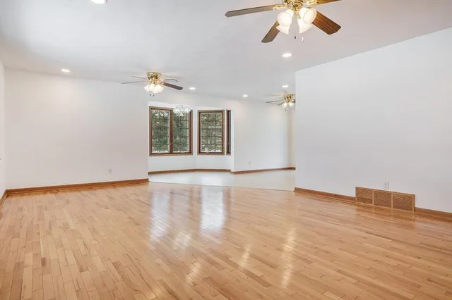 a kitchen with stainless steel appliances granite countertop a sink and a white cabinets next to a window