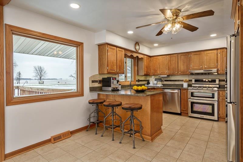 8611 Huber Road Belvidere, IL 61008 - Photo 38 of 79 a kitchen with stainless steel appliances a stove top oven and a refrigerator
