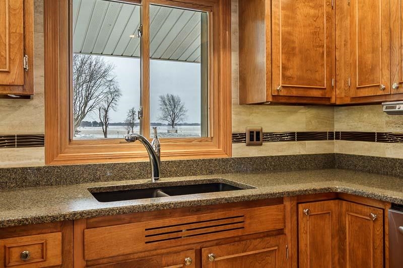 8611 Huber Road Belvidere, IL 61008 - Photo 42 of 79 a kitchen with stainless steel appliances granite countertop a sink and a white cabinets next to a window