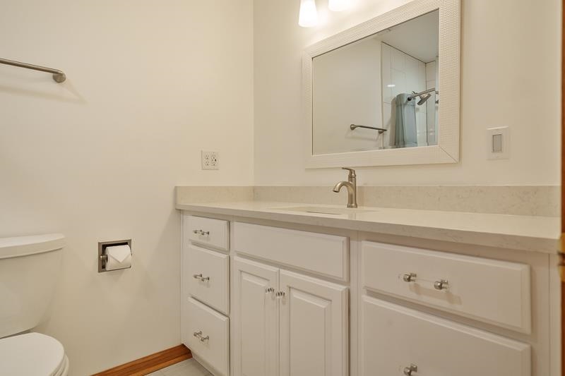 8611 Huber Road Belvidere, IL 61008 - Photo 46 of 79 a bathroom with a sink a toilet and mirror