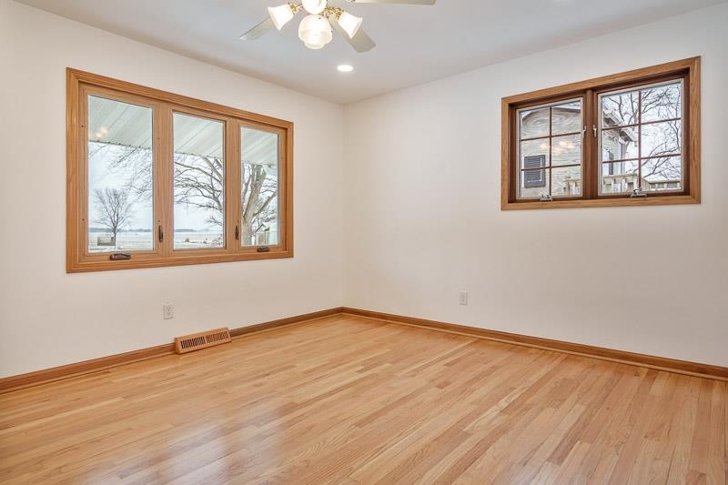 8611 Huber Road Belvidere, IL 61008 - Photo 48 of 79 a view of an empty room with wooden floor and a window