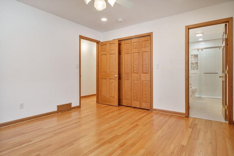 8611 Huber Road Belvidere, IL 61008 - Photo 51 of 79 an empty room with wooden floor and closet area