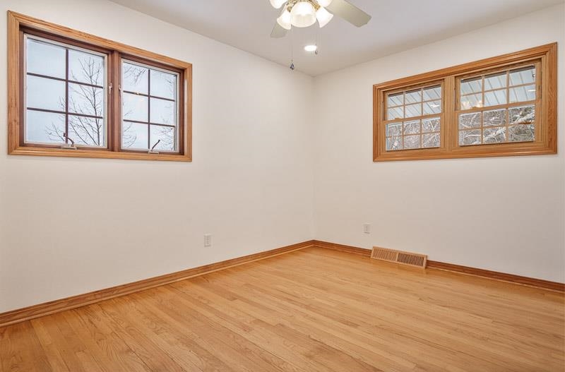 8611 Huber Road Belvidere, IL 61008 - Photo 53 of 79 a view of an empty room with wooden floor and a window