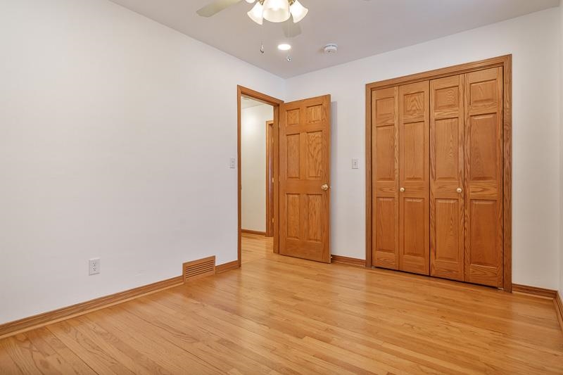 8611 Huber Road Belvidere, IL 61008 - Photo 54 of 79 an empty room with wooden floor and closet area