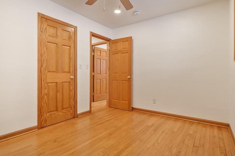 8611 Huber Road Belvidere, IL 61008 - Photo 56 of 79 an empty room with wooden floor and closet area