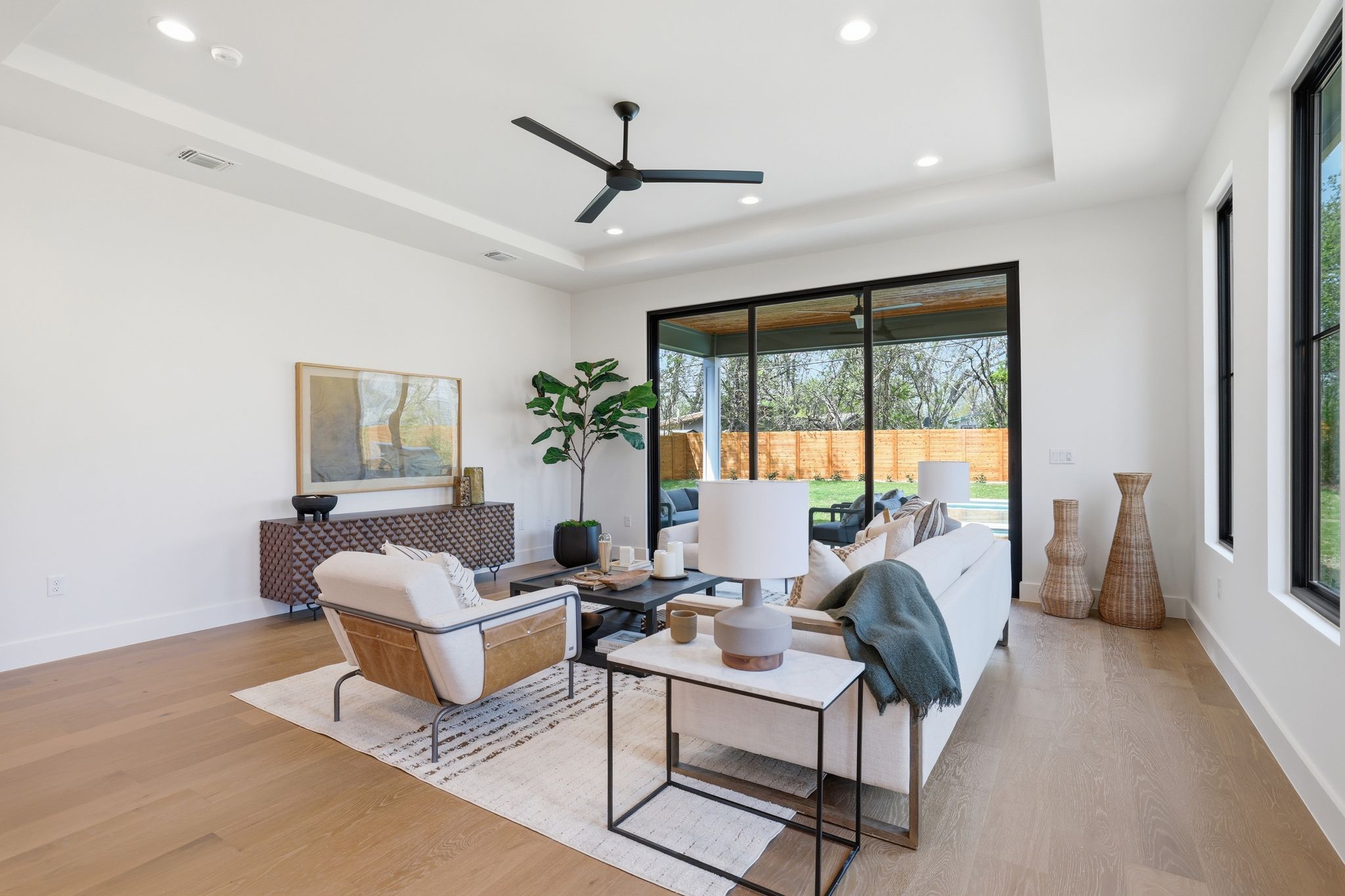 4500 Jinx Avenue Austin, TX 78745 - Photo 19 of 40 Living room featuring a ceiling fan, light wood-style floors, recessed lighting, and a raised ceiling