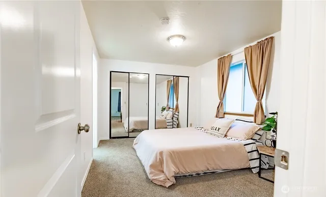 a bedroom with a bed and a window