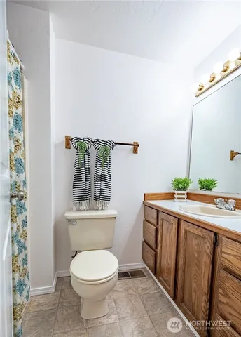 a bathroom with a toilet a sink and a window
