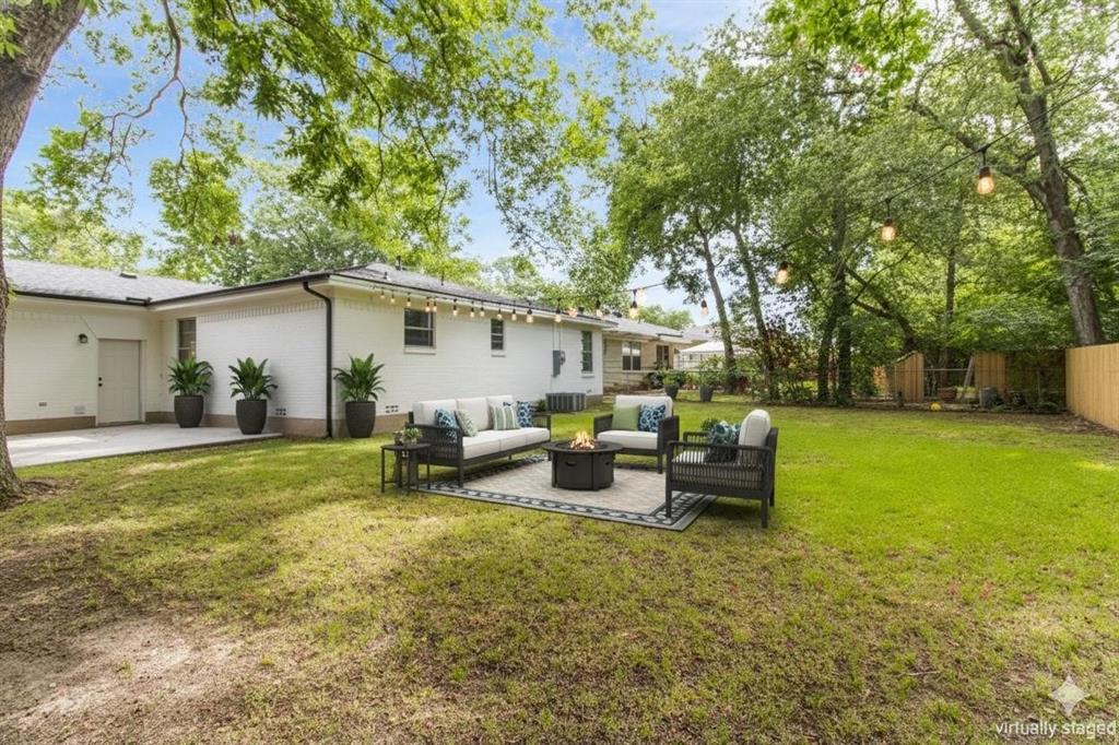 1818 Belden Street Sherman, TX 75092 - Photo 27 of 28 a view of a patio with table and chairs potted plants and large tree
