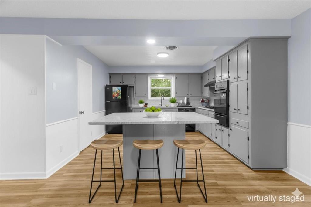 1818 Belden Street Sherman, TX 75092 - Photo 4 of 28 a kitchen with stainless steel appliances kitchen island granite countertop a refrigerator and a stove top oven