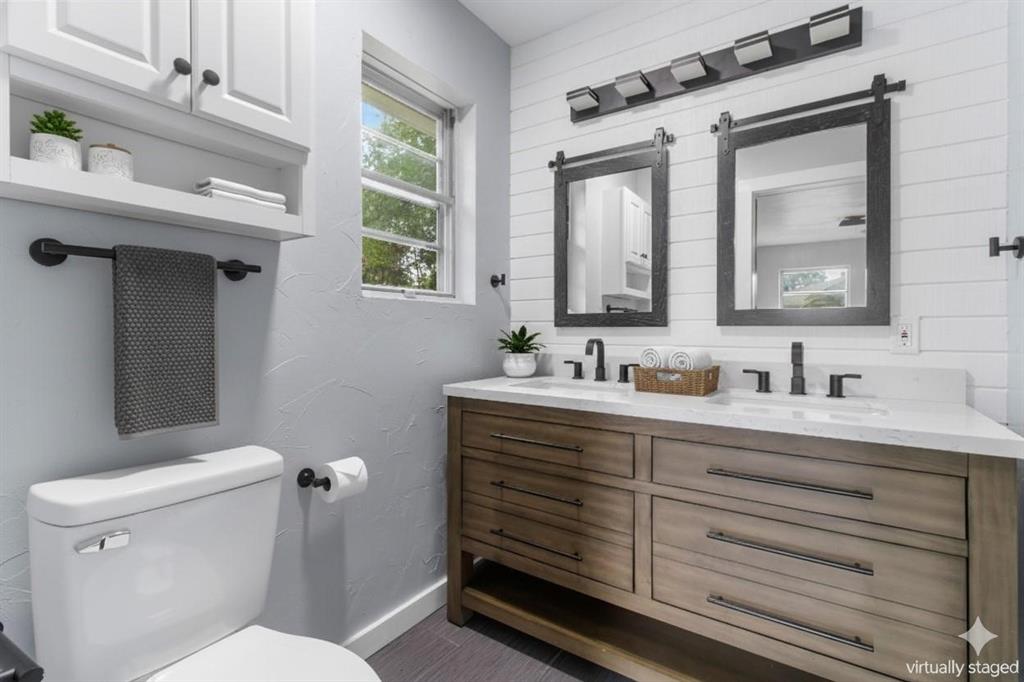 1818 Belden Street Sherman, TX 75092 - Photo 9 of 28 a bathroom with a toilet sink and mirror