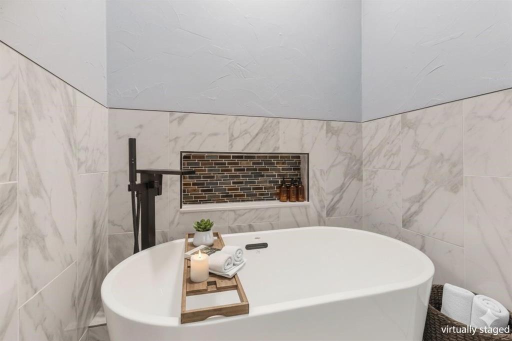 1818 Belden Street Sherman, TX 75092 - Photo 10 of 28 a bathroom with a white bath tub and a shower curtain