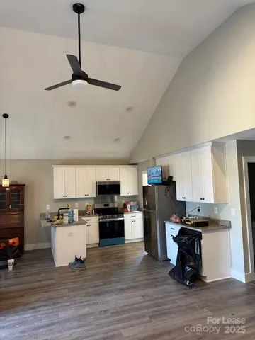 a kitchen with a refrigerator and a stove top oven