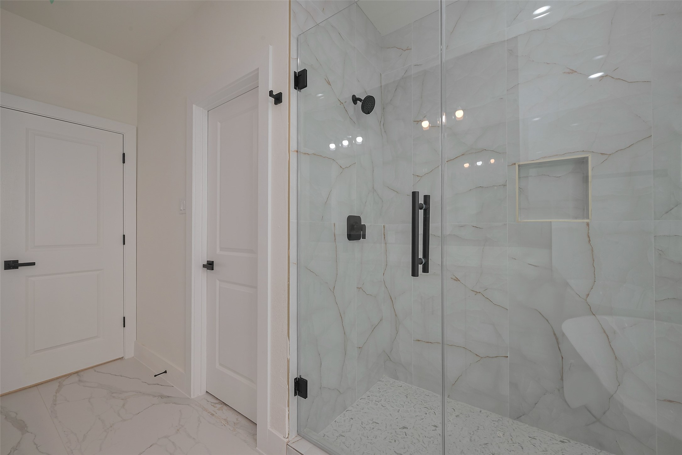 2422 Dalview Street Houston, TX 77091 - Photo 14 of 24 Step into luxury with the walk-in
glass-enclosed shower, featuring fullheight designer tile, a built-in product
niche, and matte black accents for
that perfect Instagram-worthy finish.
