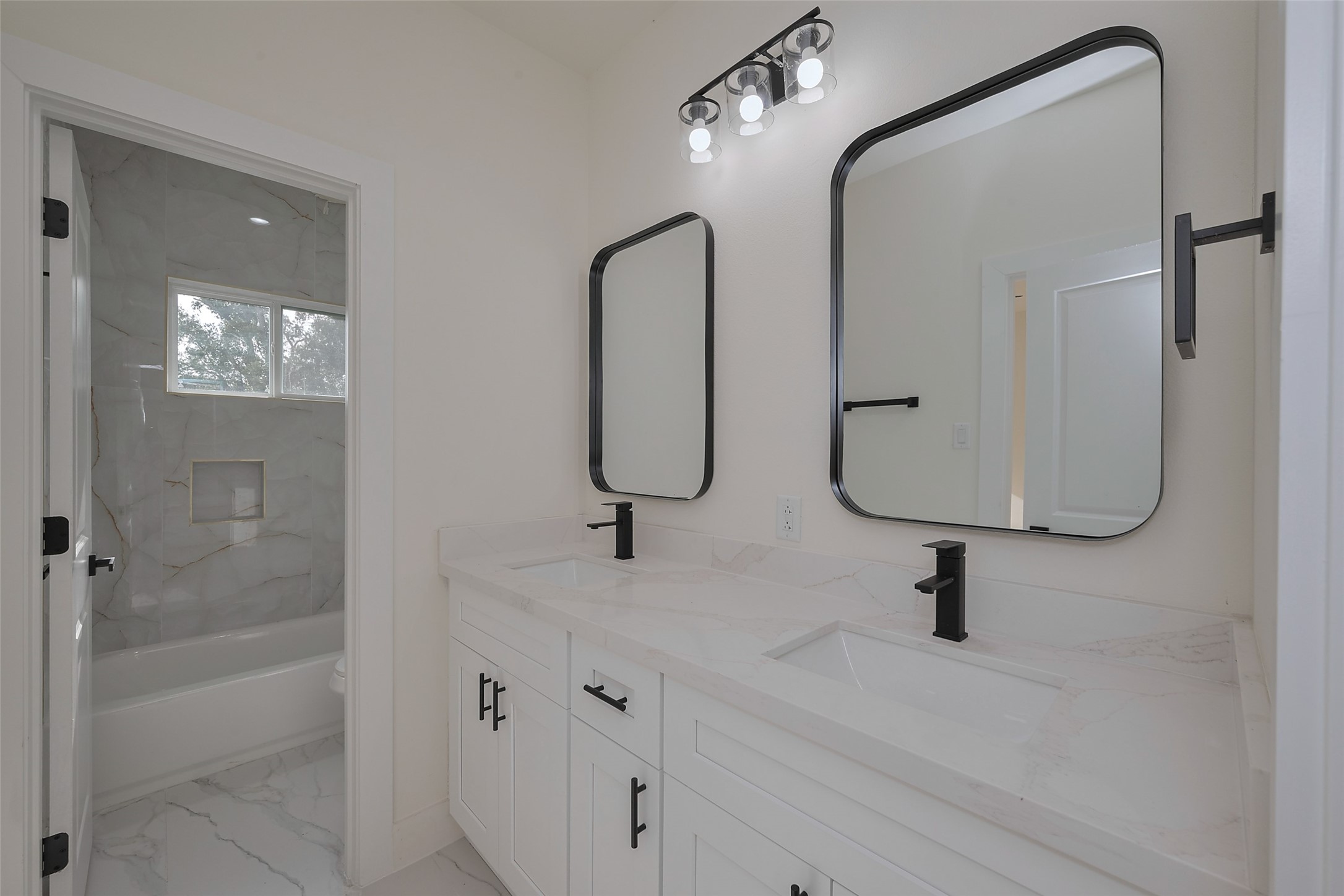 2422 Dalview Street Houston, TX 77091 - Photo 20 of 24 This beautifully designed bathroom
includes a dual sink vanity, ideal for
sharing, and a sleek tub & shower
combo, blending functionality with
modern style.