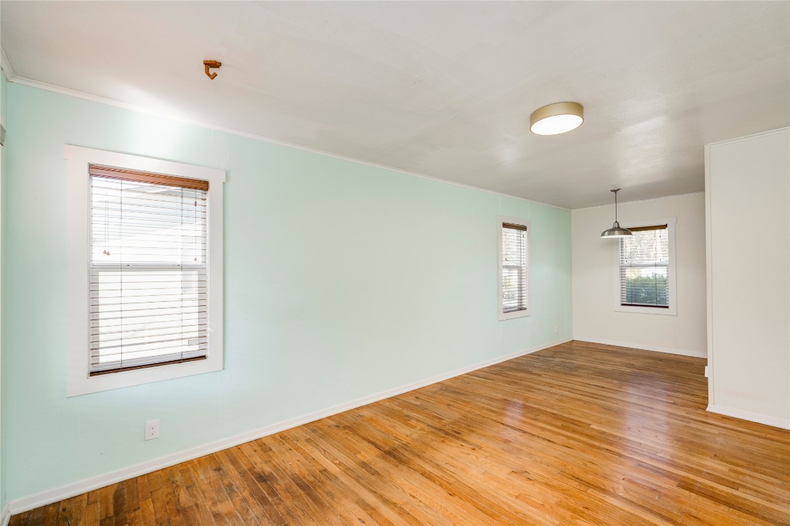 4804 Tanney Street Austin, TX 78721 - Photo 13 of 35 a view of empty room with wooden floor and fan