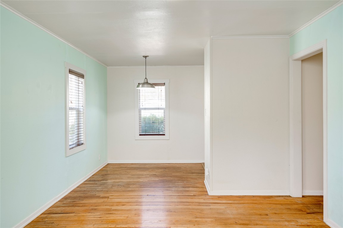4804 Tanney Street Austin, TX 78721 - Photo 15 of 35 a view of an empty room with wooden floor and a window