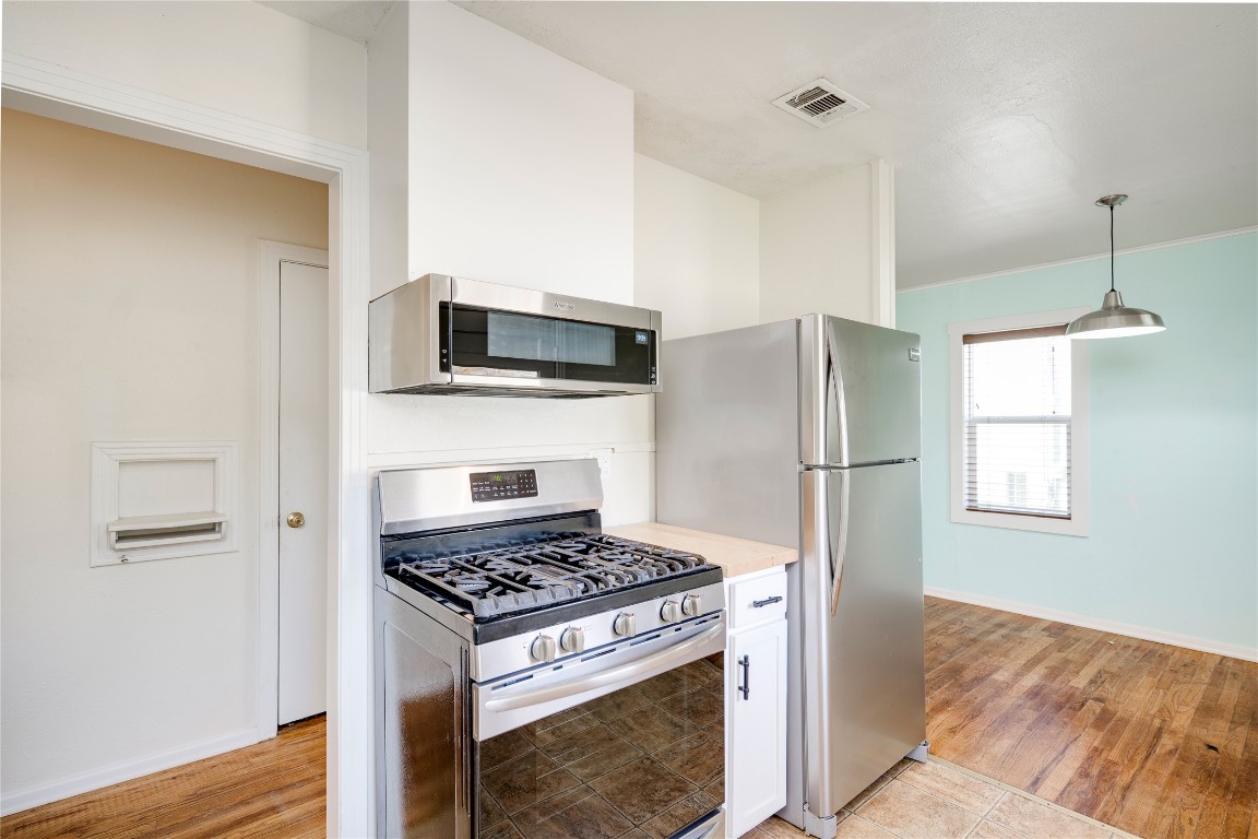 4804 Tanney Street Austin, TX 78721 - Photo 21 of 35 a kitchen with a stove and a microwave