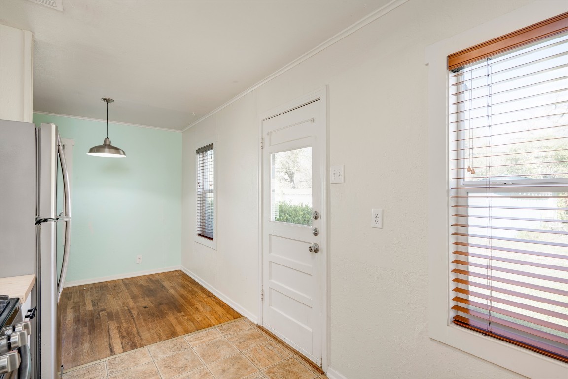 4804 Tanney Street Austin, TX 78721 - Photo 22 of 35 a view of hallway with window and wooden floor