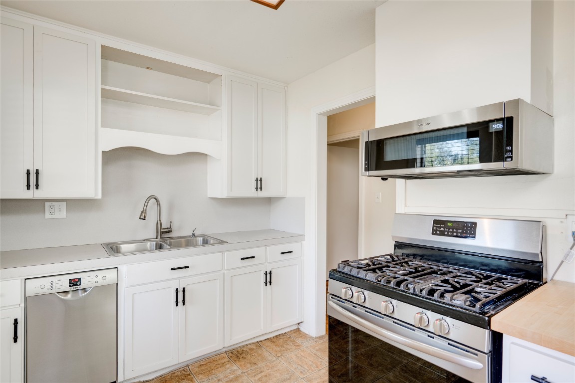 4804 Tanney Street Austin, TX 78721 - Photo 24 of 35 a kitchen with white cabinets and appliances