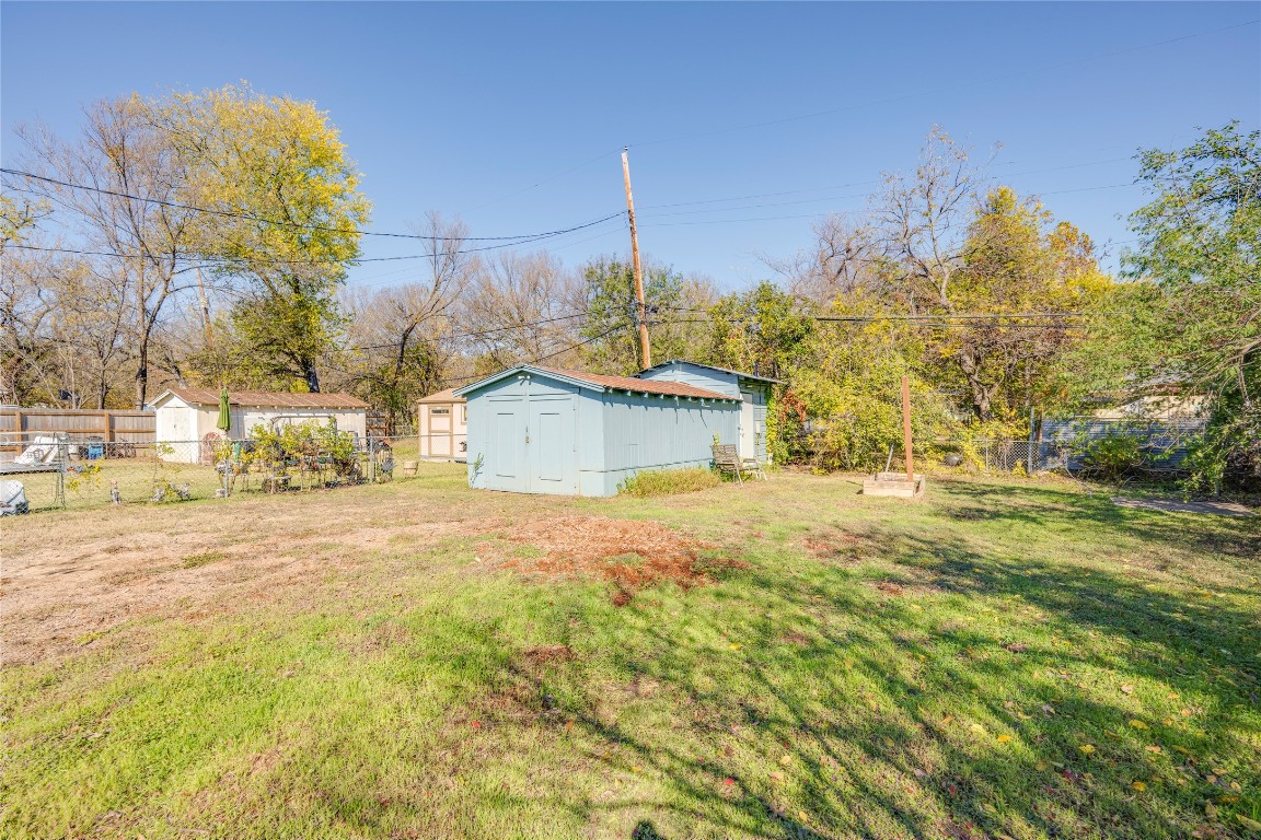 4804 Tanney Street Austin, TX 78721 - Photo 7 of 35 a yellow house with trees in front of it