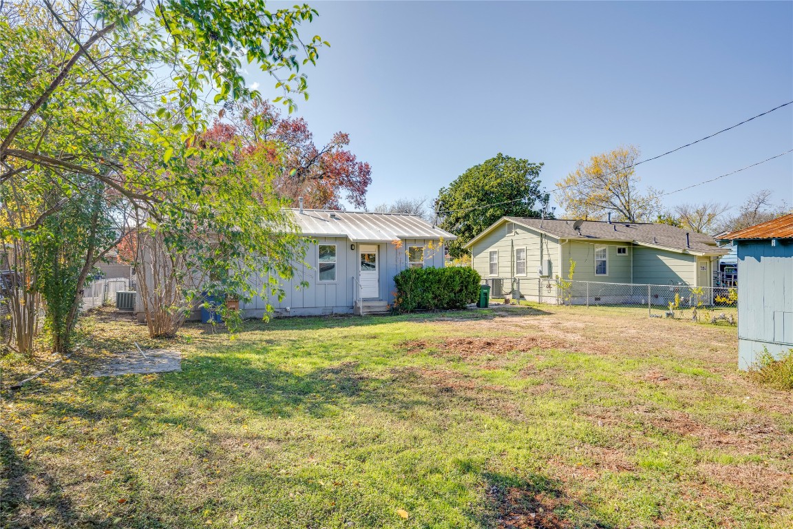 4804 Tanney Street Austin, TX 78721 - Photo 9 of 35 a front view of a house with a yard and garage