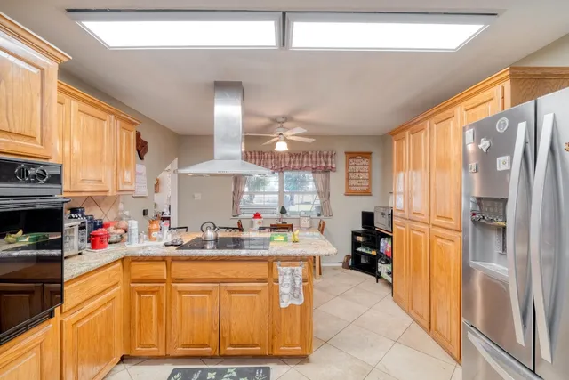a kitchen with stainless steel appliances a refrigerator sink and cabinets