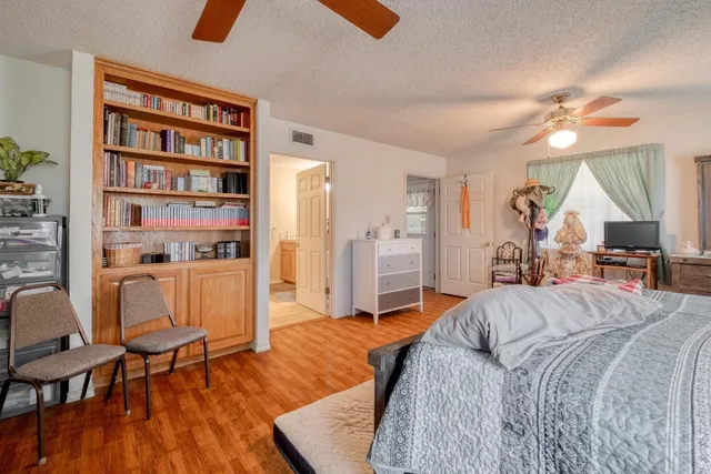 a bed room with a bed and a chair