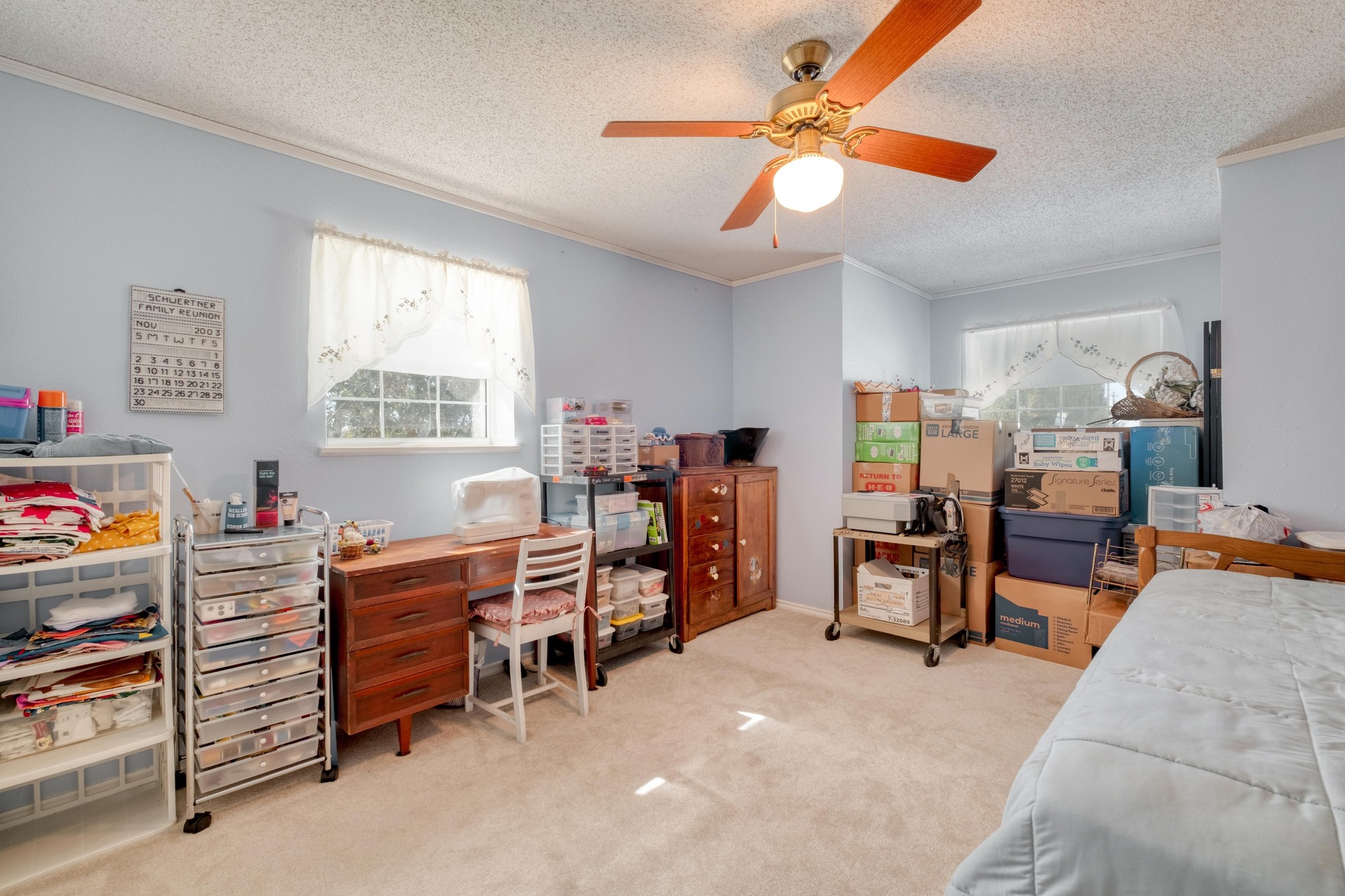153 Pleasant Grove Road Elgin, TX 78621 - Photo 21 of 34 Bedroom featuring light carpet, ornamental molding, a textured ceiling, a ceiling fan, and a desk