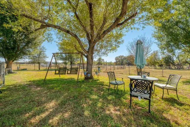 a view of a lake with a table and chairs