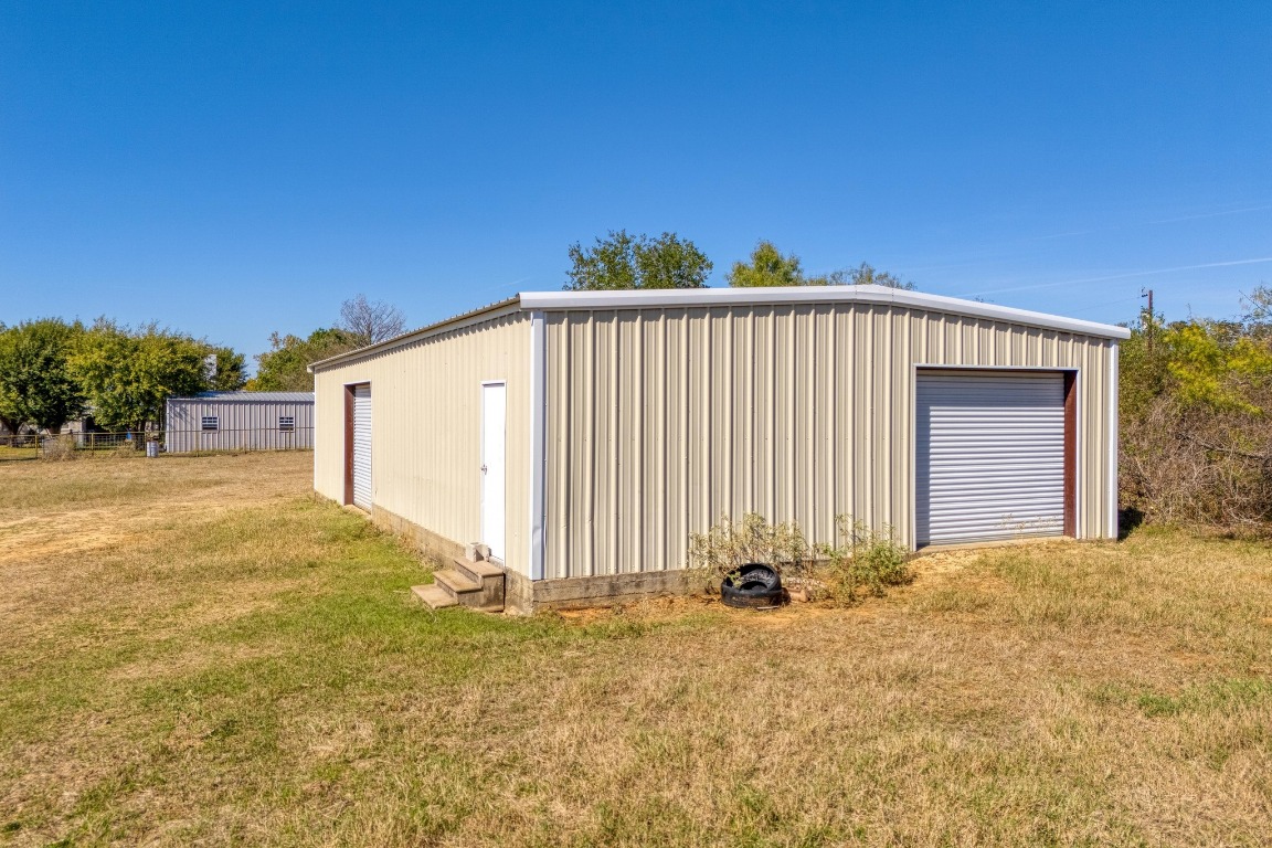 153 Pleasant Grove Road Elgin, TX 78621 - Photo 28 of 34 a view of a house with backyard and trees