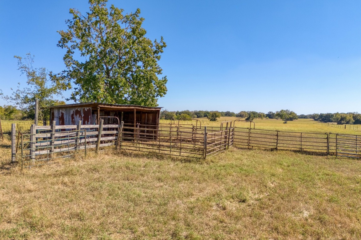 153 Pleasant Grove Road Elgin, TX 78621 - Photo 29 of 34 a view of a lake with a house in the background