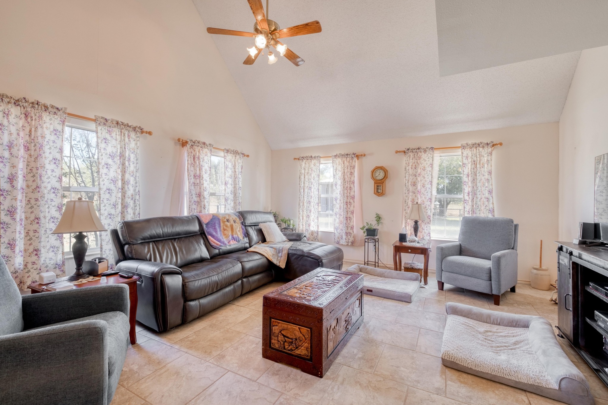 153 Pleasant Grove Road Elgin, TX 78621 - Photo 6 of 34 Living room with high vaulted ceiling, ceiling fan, and light tile patterned floors