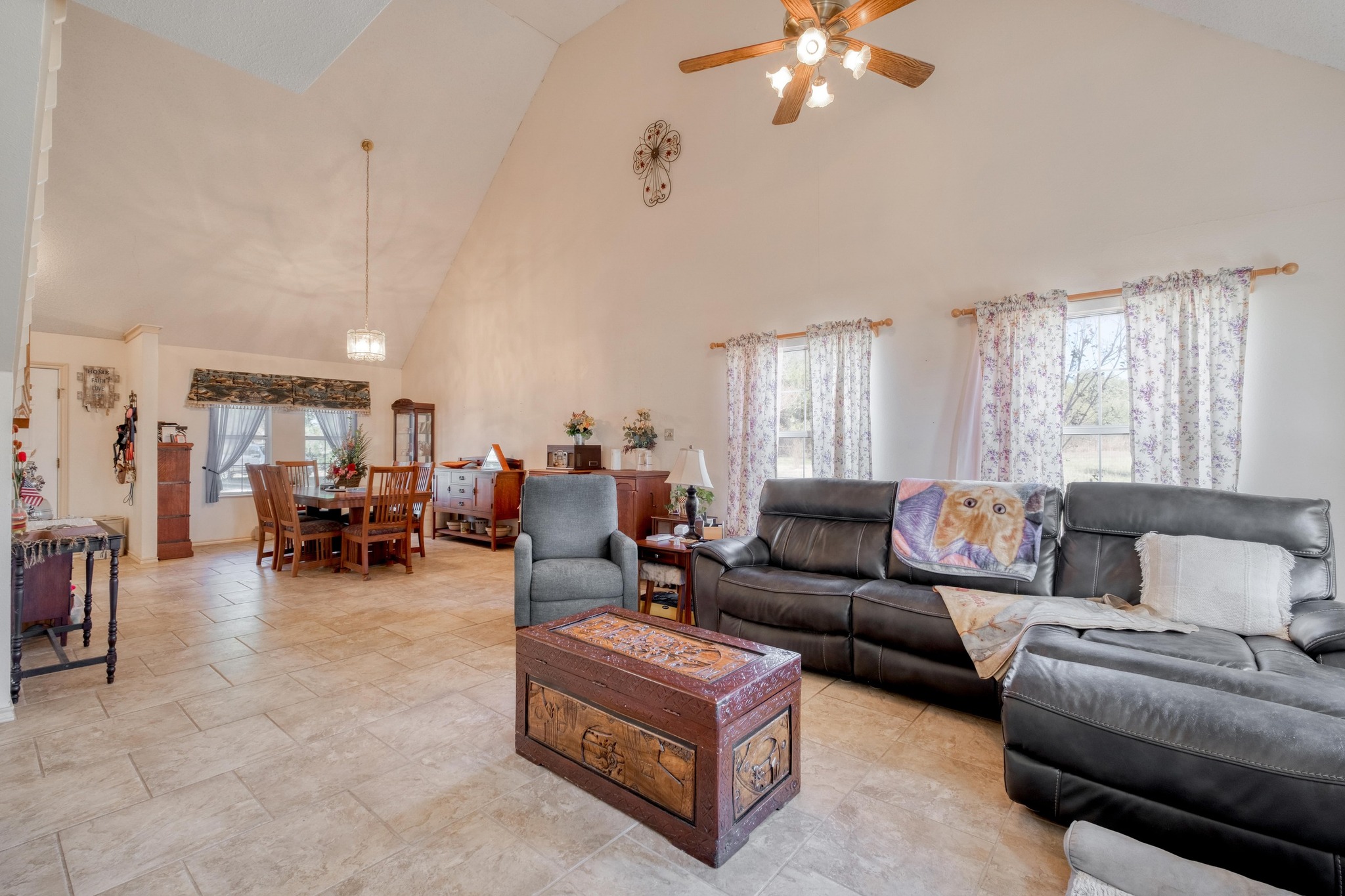 153 Pleasant Grove Road Elgin, TX 78621 - Photo 9 of 34 Living room with high vaulted ceiling and ceiling fan