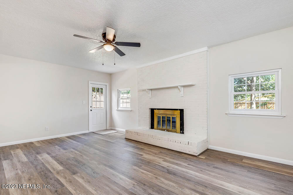4066 Ferrarra Street Jacksonville, FL 32217 - Photo 14 of 25 a view of empty room with wooden floor and ceiling fan