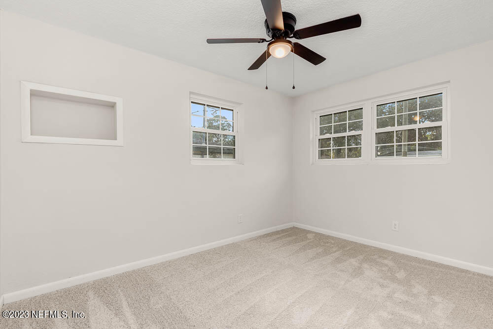 4066 Ferrarra Street Jacksonville, FL 32217 - Photo 17 of 25 an empty room with windows