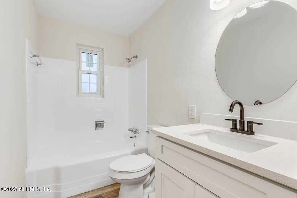 4066 Ferrarra Street Jacksonville, FL 32217 - Photo 19 of 25 a bathroom with a sink toilet and shower