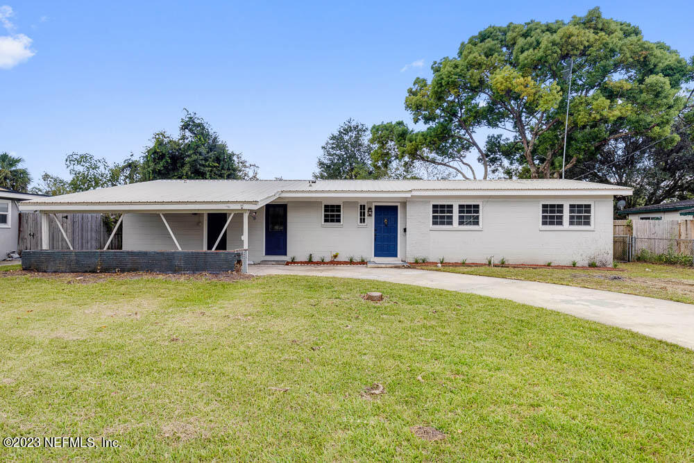 4066 Ferrarra Street Jacksonville, FL 32217 - Photo 2 of 25 a front view of house with yard barbeque oven and outdoor seating