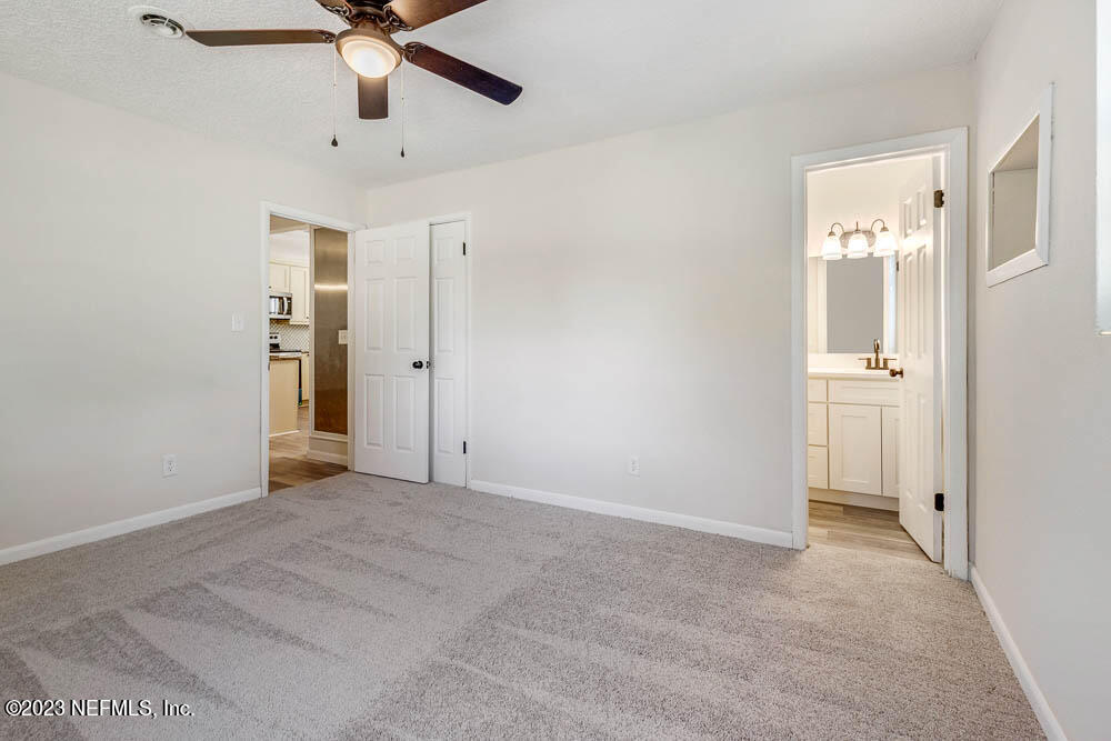 4066 Ferrarra Street Jacksonville, FL 32217 - Photo 21 of 25 an empty room with fan and entryway